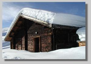 verschneite Almhütte